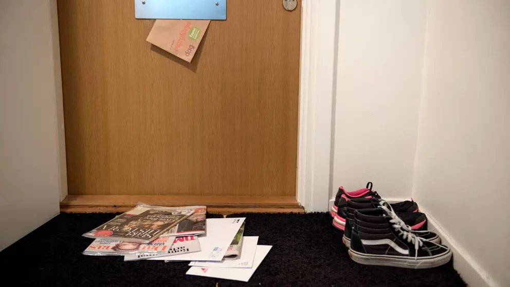 A door with a lot of letters on the floor.