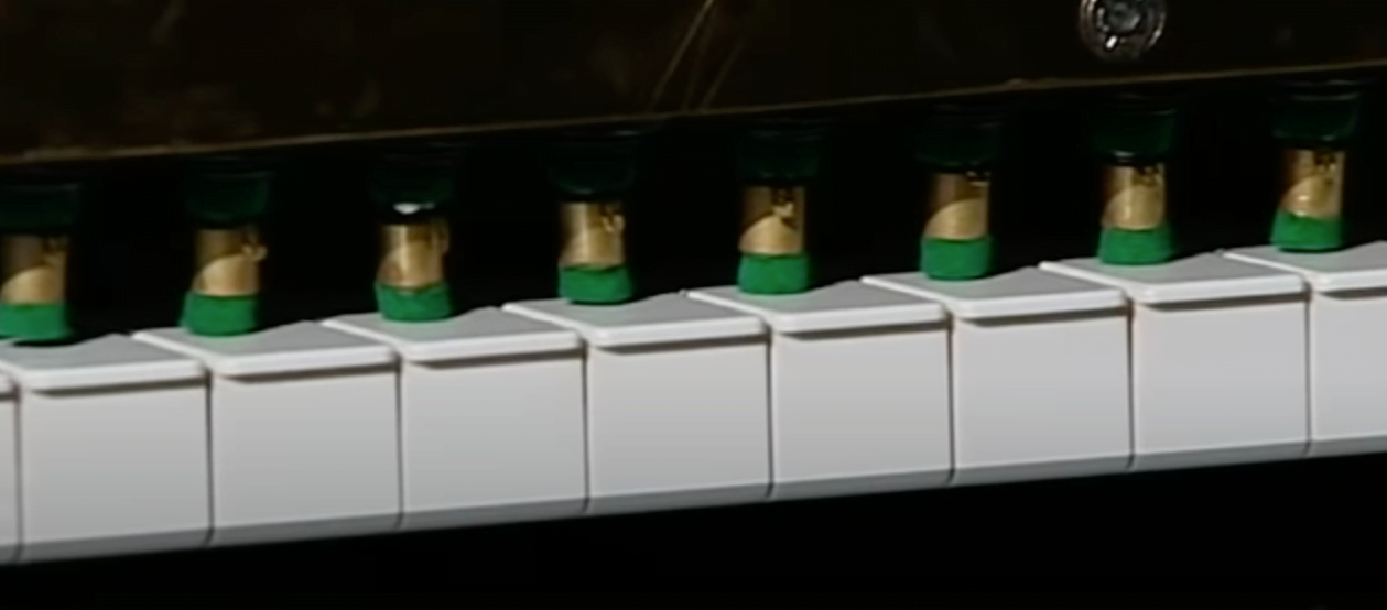 Computerized fingers pressing on Piano keys